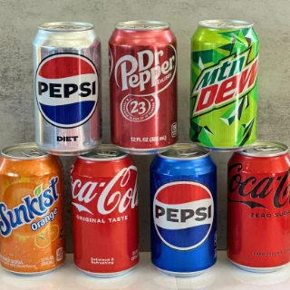 Cans of Pepsi, Diet Pepsi, Dr Pepper, Mountain Dew, Sunkist orange, Coca-Cola and Coke Zero stacked up