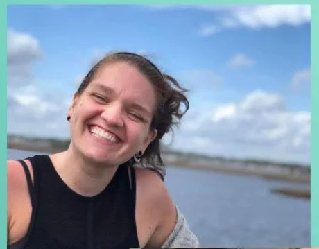 Alexx, a Dairy Duck truck operator, smiling by the water